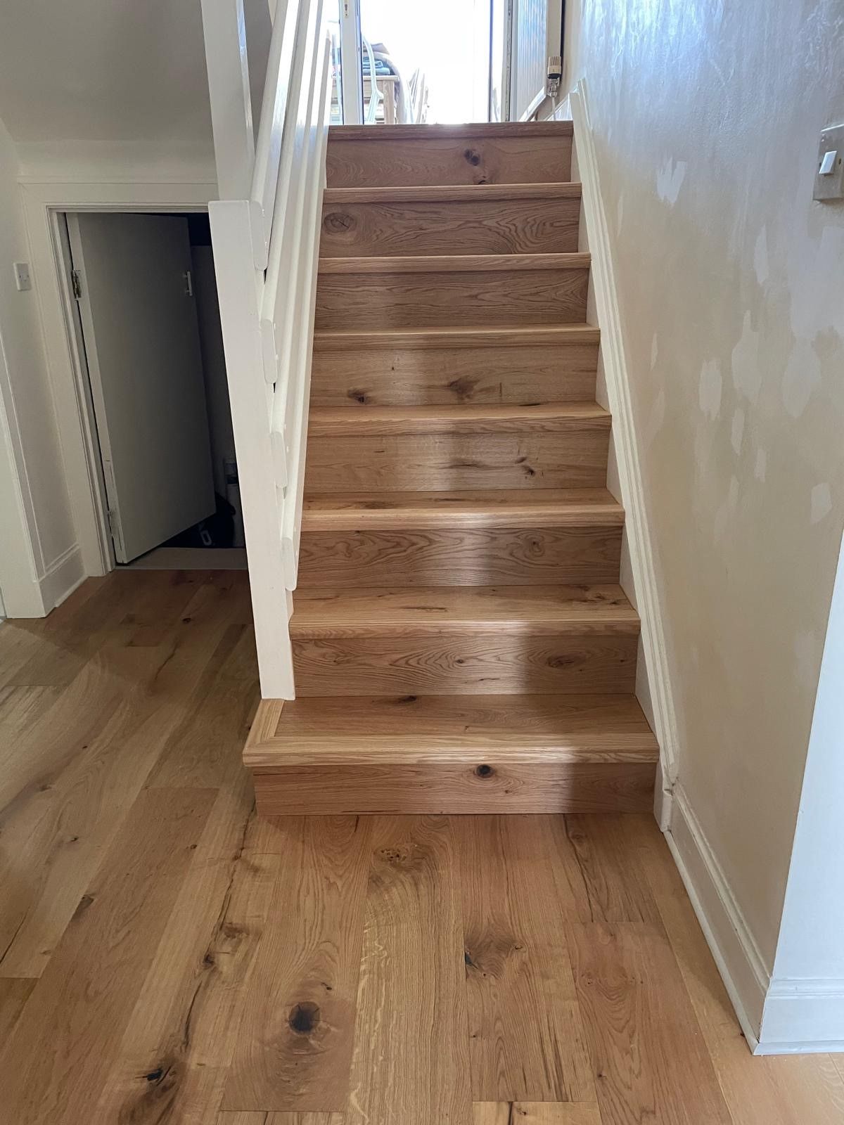 Photo of newly laid hardwood flooring in a staircase, performed by SR Flooring in Edinburgh