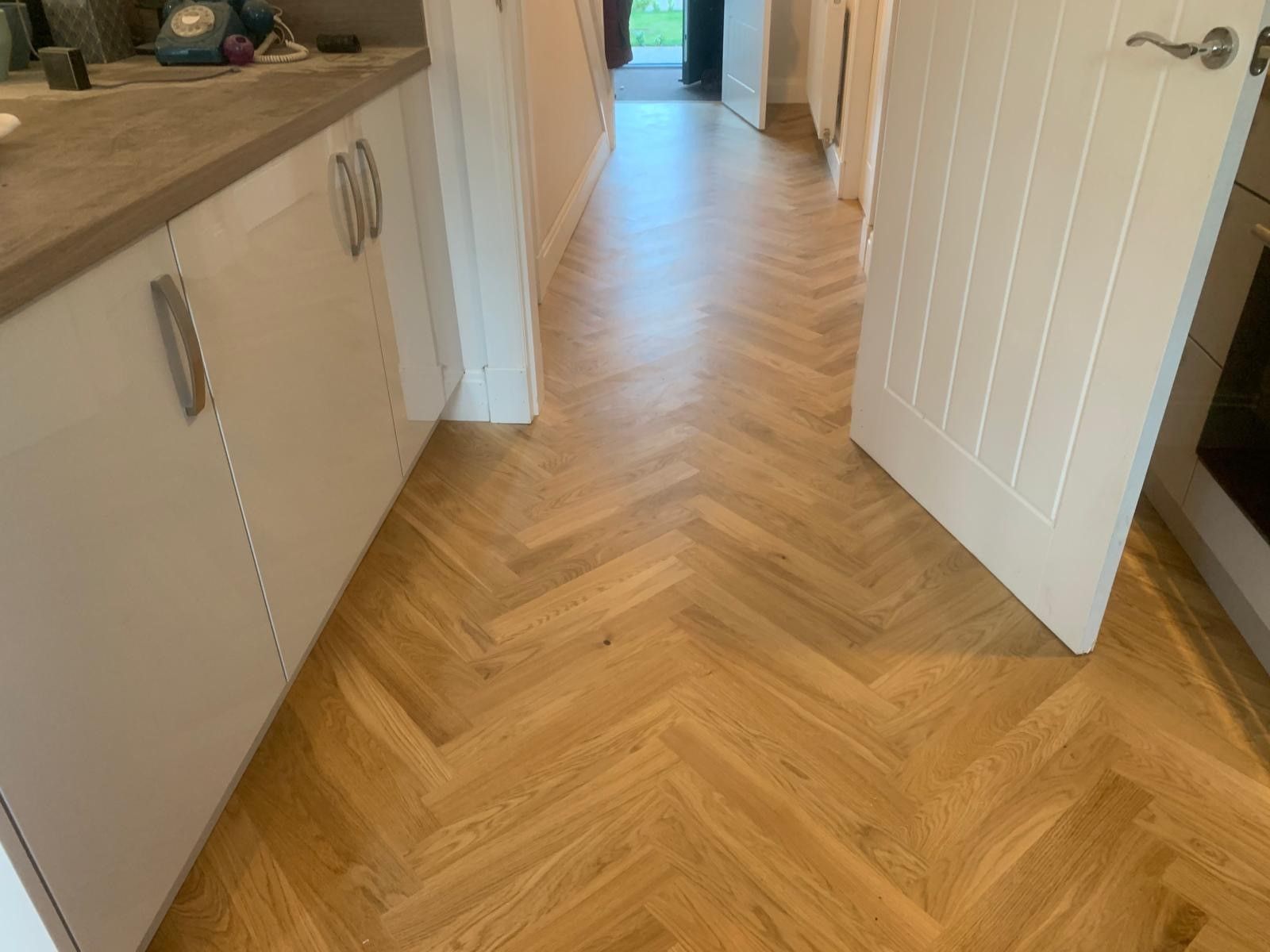 Photo of newly laid hardwood flooring in a kitchen, performed by SR Flooring in Edinburgh