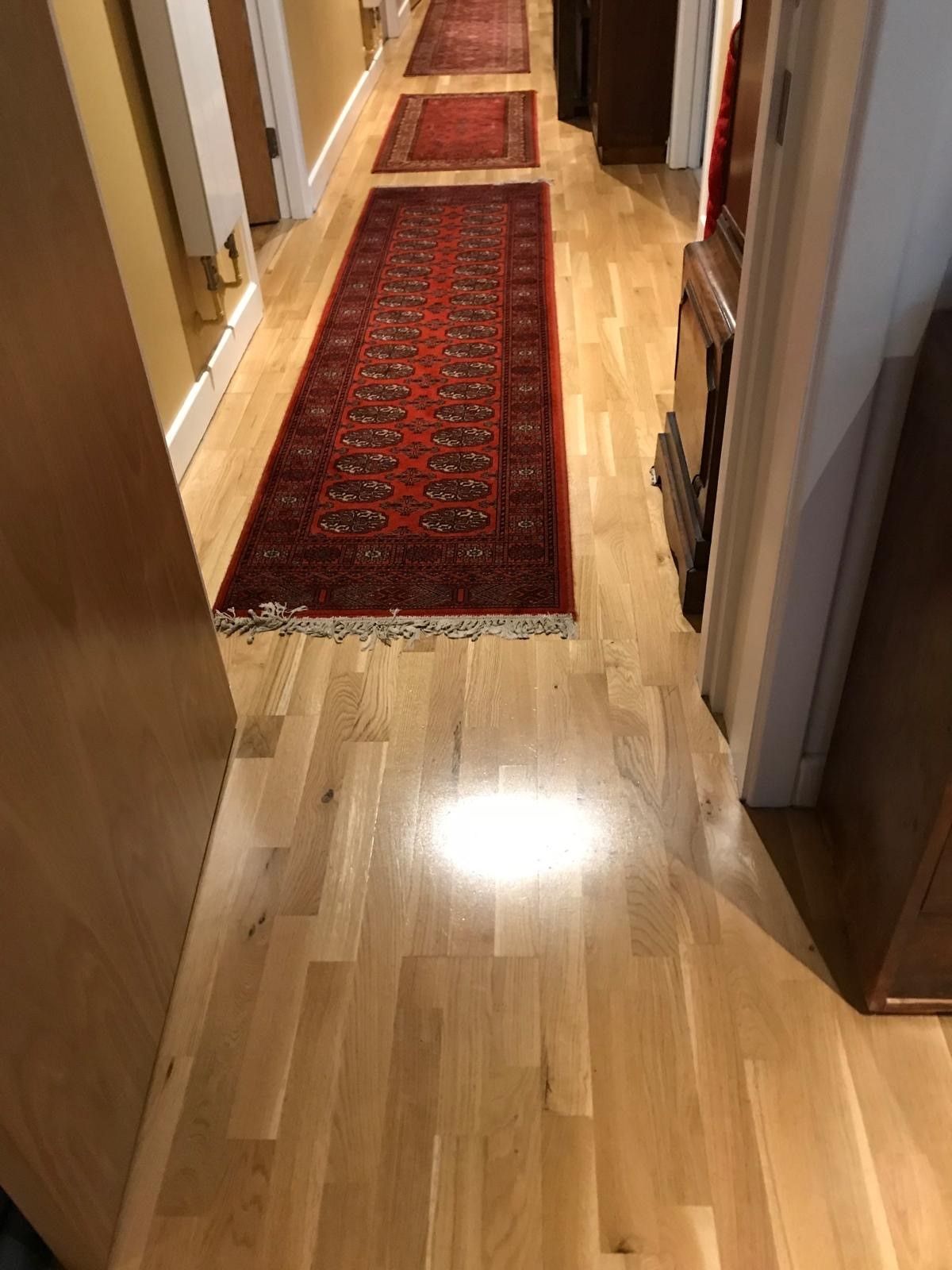 Photo of newly laid hardwood flooring in a hallway, performed by SR Flooring in Edinburgh