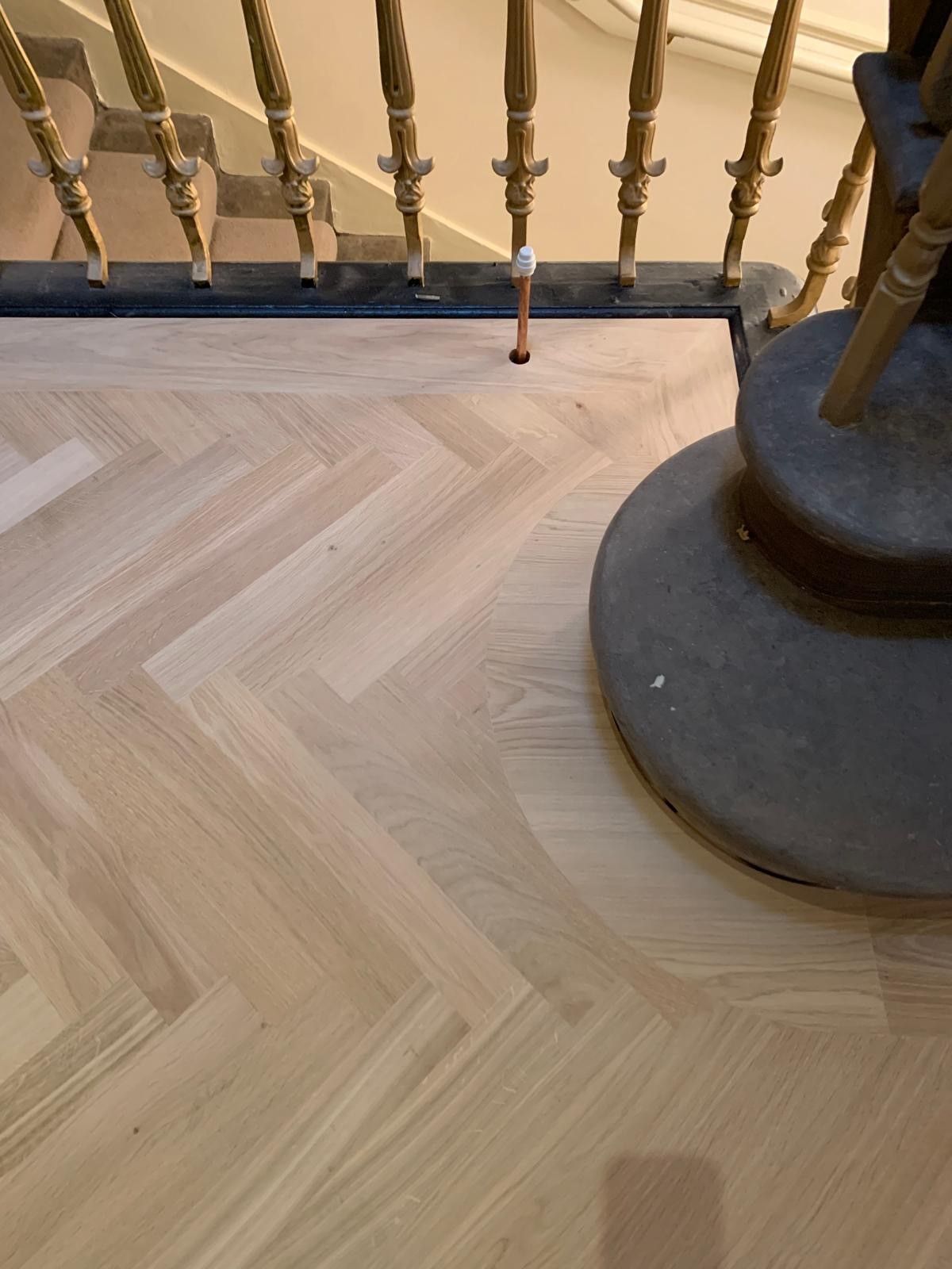 Photo of newly laid hardwood flooring in a landing stairwell, performed by SR Flooring in Edinburgh