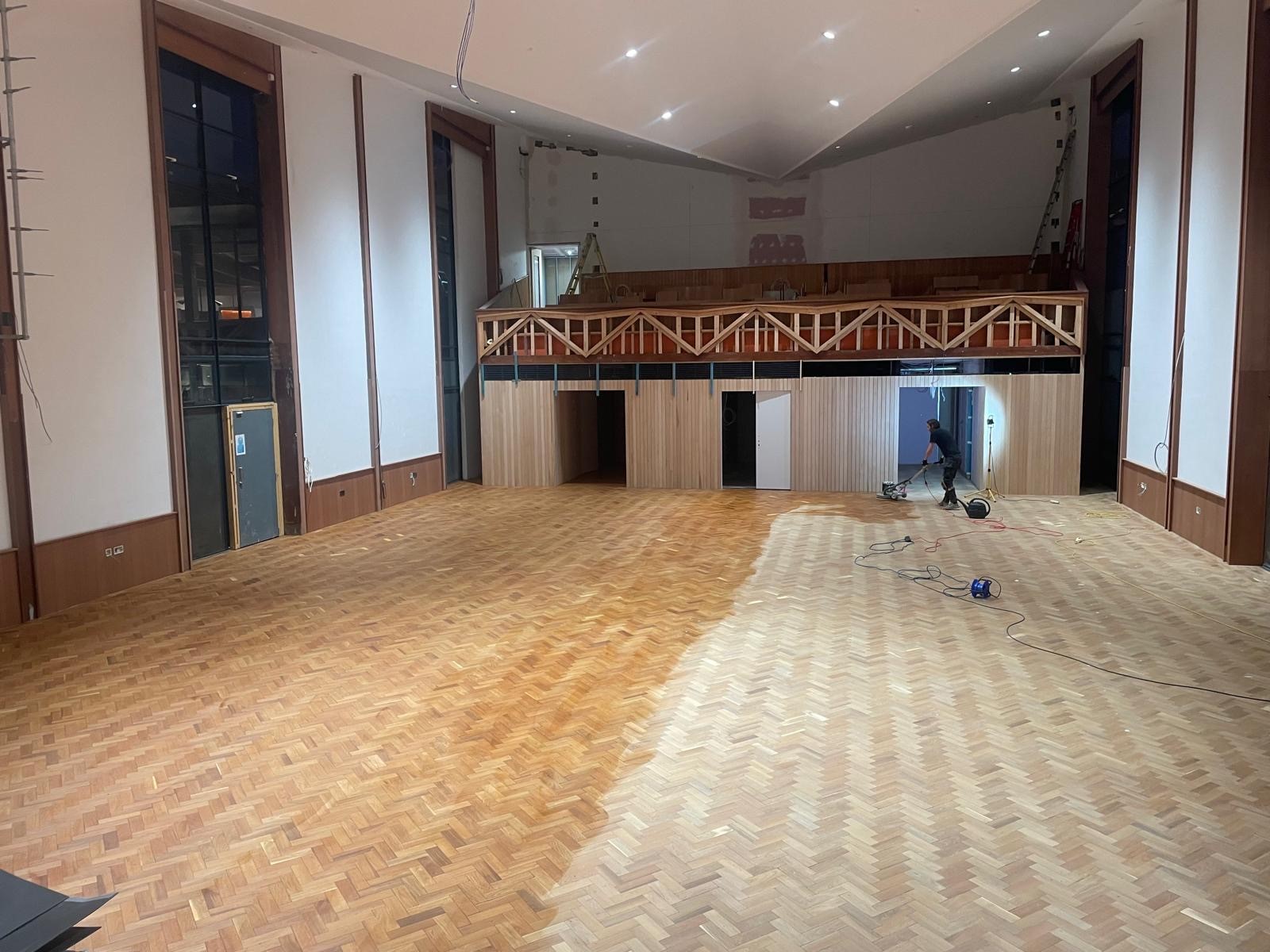 Photo of flooring in a large hall which in the process of being restored by sanding and oiling, performed by SR Flooring in Edinburgh